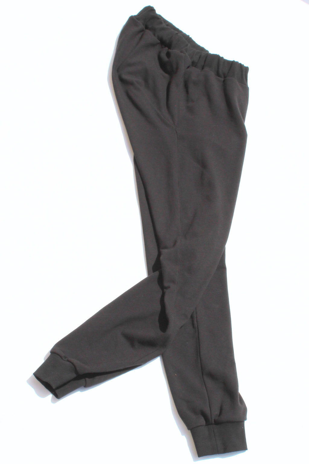Vilber's adaptive joggers laid flat on white background, angled view showing the tapered leg and ribbed cuff detail.