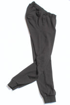 Vilber's adaptive joggers laid flat on white background, angled view showing the tapered leg and ribbed cuff detail.