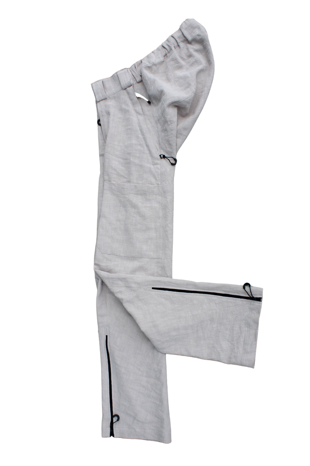 Side view of Vilber's adaptive trousers laid flat, showing the balanced side line and  zip at the inner leg.