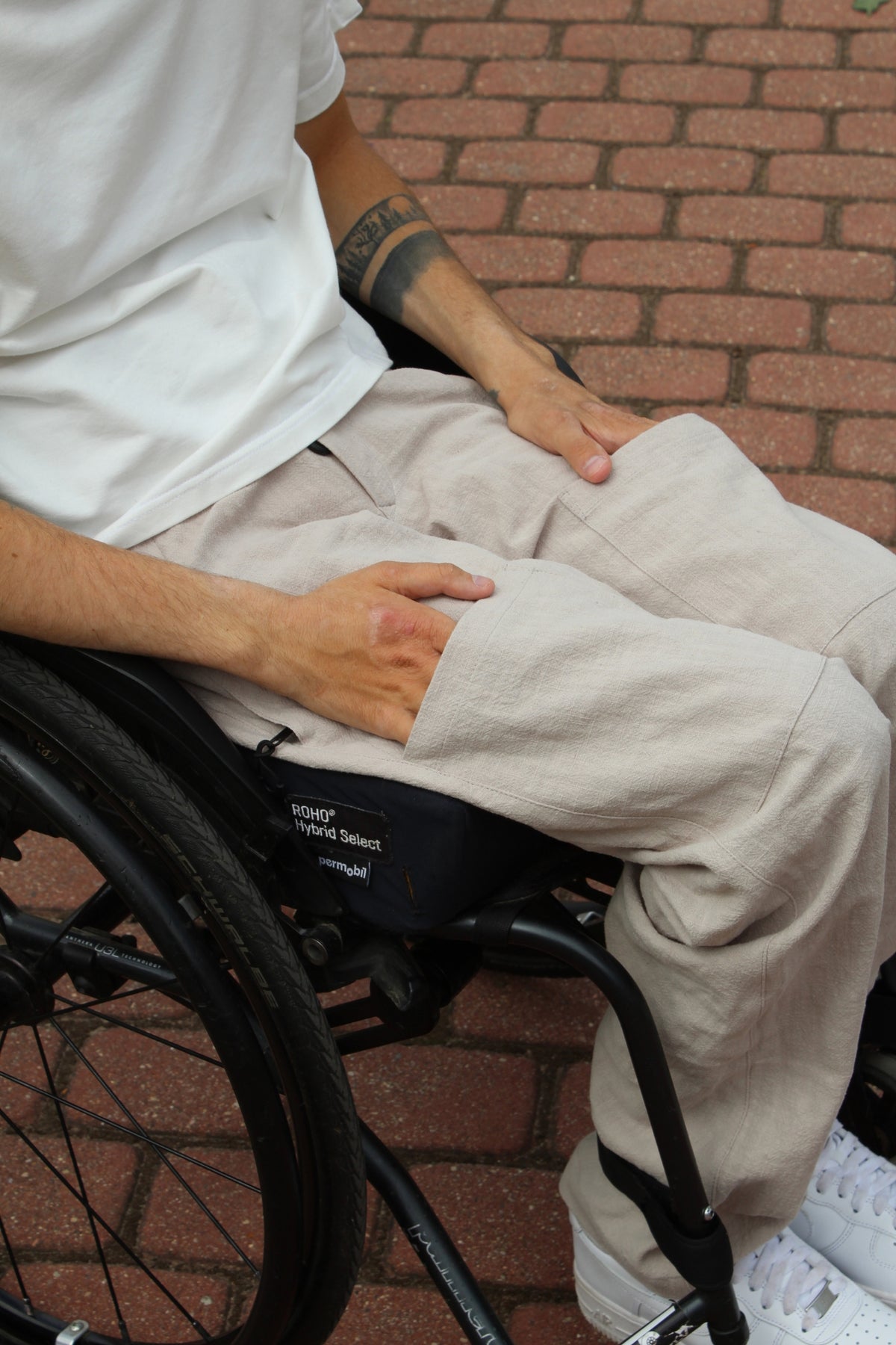 Close-up of the magnetic hook-and-hook closure on Vilber's adaptive trousers, showing how the front access panel aligns and locks into place.