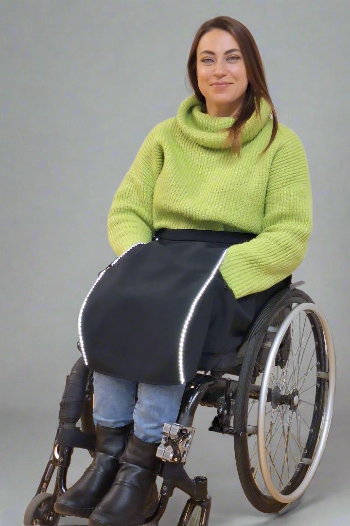 Woman in a wheelchair with lap cover for wheelchair users